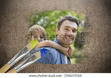 Composite image of father and son in the park with paintbrush dipped in blue against weathered surface