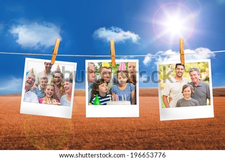 Composite image of instant photos hanging on a line against field and blue sky