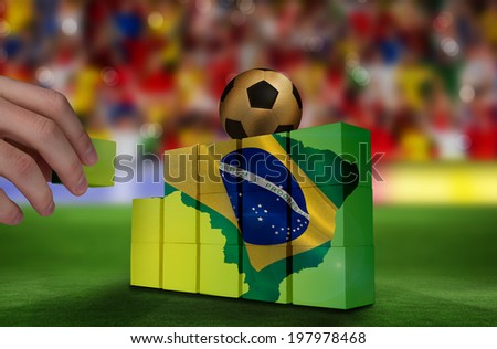 Hand building wall of green brazil outline with flag