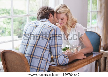 Young couple enjoying a meal together at home in the dining room