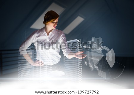 Redhead businesswoman using interactive desk against white room with floorboards