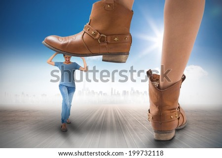 Composite image of cowboy boots stepping on girl against cityscape on the horizon