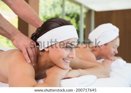 Pretty friends getting massages together in the health spa