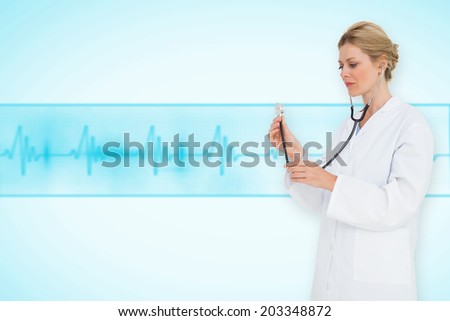 Blonde doctor listening with stethoscope against medical background with blue ecg line