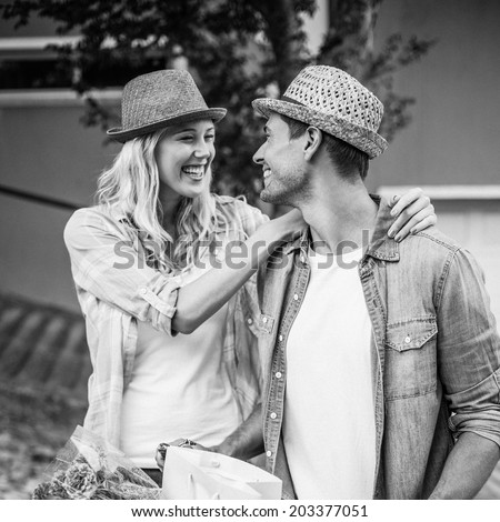 Hip young couple going for a bike ride in black and white