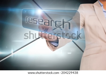 Businesswoman pointing to word research against futuristic screen with lines