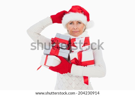 Festive woman scratching head and holding gifts on white background