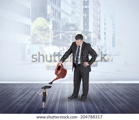 Mature businessman watering tiny businesswoman against urban projection on wall