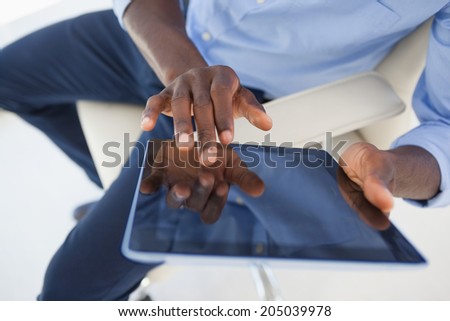 Businessman using his tablet pc in his office