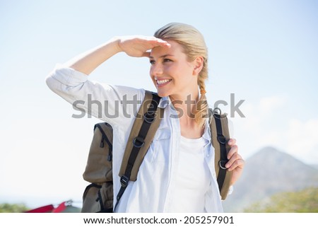 Attractive hiking blonde looking around on a sunny day