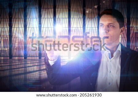 Businessman presenting the word transfer against room with large window looking on city