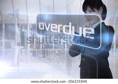 Businesswoman looking at the word overdue against room with large window looking on city