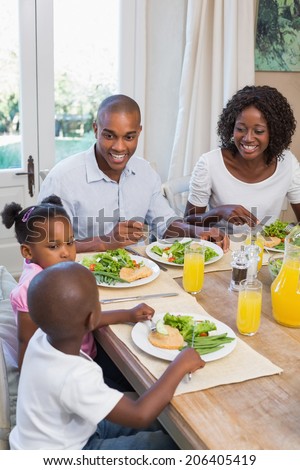 Happy family enjoying a healthy meal together at home in the kitchen