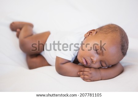 Baby boy sleeping peacefully on couch at home in the living room