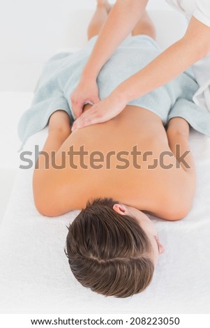 Close-up of an attractive young woman receiving back massage at spa center
