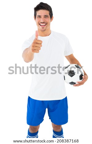 Football player in white holding ball showing thumbs up on white background