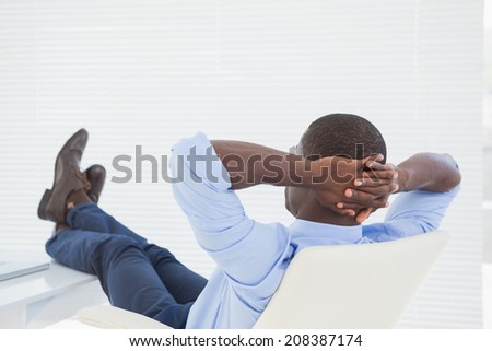 Relaxed businessman with his feet up in his office