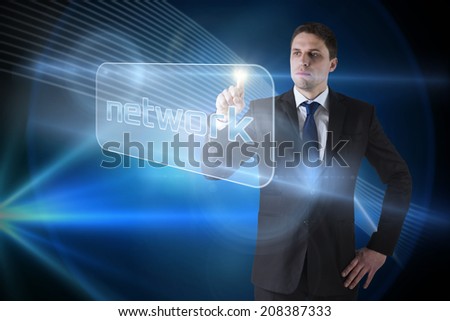 Businessman pointing to word network against shiny lines on black background