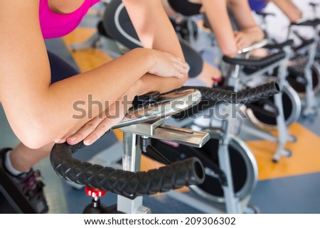 Spin class working out in a row at the gym