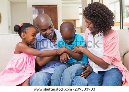 Happy family relaxing on the couch at home in the living room