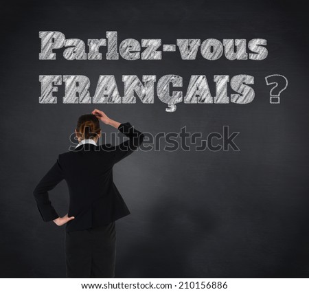 Young businesswoman standing and thinking against blackboard, Do you speak French?