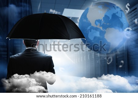 Mature businessman holding an umbrella against holographic earth in hallway