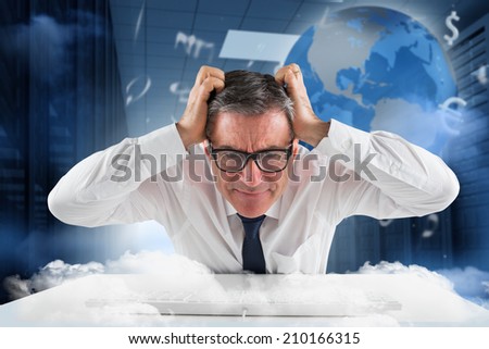 Stressed businessman using a keyboard against holographic earth in hallway