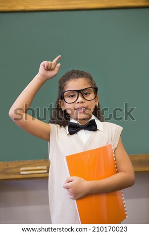 Cute pupil dressed up as teacher in classroom at the elementary school