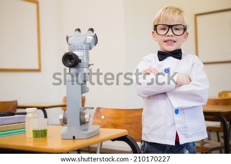Cute pupil dressed up as scientist in classroom at the elementary school