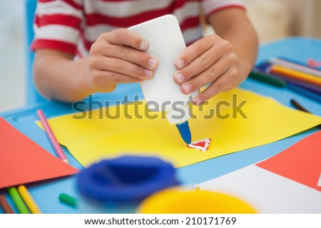 Cute little boy making art in classroom at the nursery school
