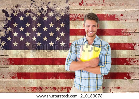 Young student smiling against usa flag in grunge effect
