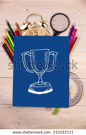 Winners cup against students desk with blue page