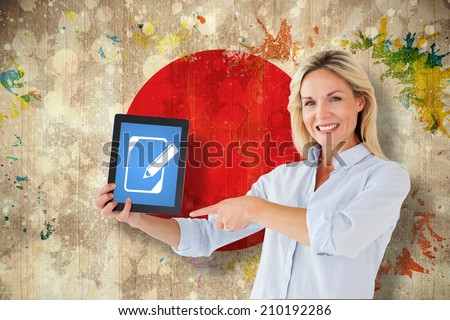 Mature student pointing to tablet against grunge japan flag