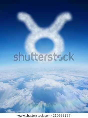 Cloud in shape of taurus star sign against blue sky over clouds at high altitude