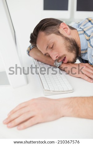 Sleeping casual businessman at his desk in his office