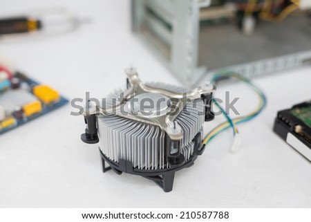 Fan beside cpu and cables on white desk