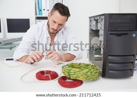 Computer engineer working on broken cables in his office