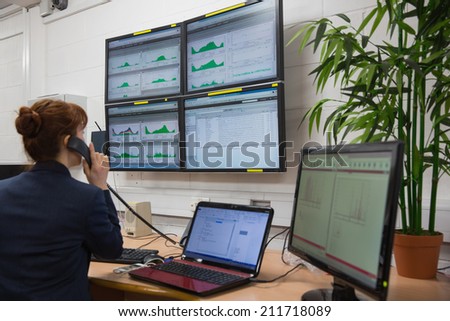 Technician sitting in office running diagnostics in large data center