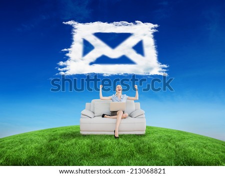 Composite image of cheering beautiful businesswoman sitting on couch against cloud email