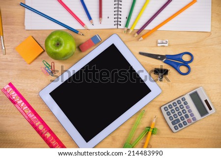 Students table with school supplies and tablet pc