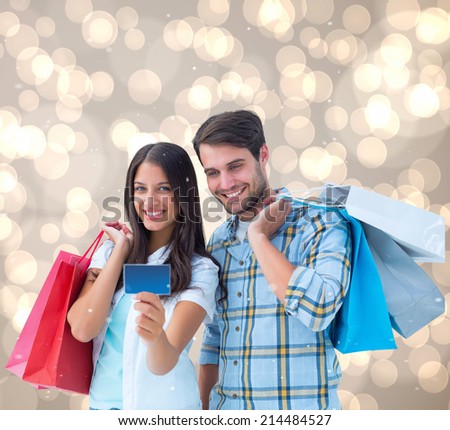 Couple with shopping bags and credit card against light glowing dots design pattern