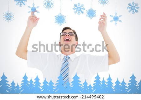 Geeky happy businessman with arms up against snowflakes and fir trees in blue
