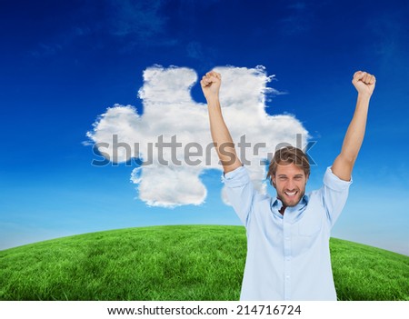 Composite image of happy man celebrating success with arms up against cloud jigsaw piece