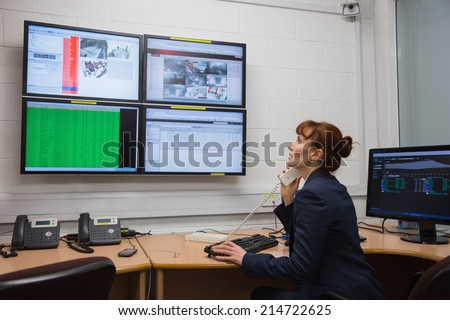 Technician sitting in office running diagnostics in large data center