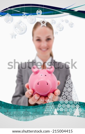 Piggy bank being offered by smiling bank employee against christmas frame