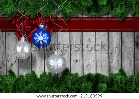 Digital hanging christmas bauble decoration against fir tree branches forming frame