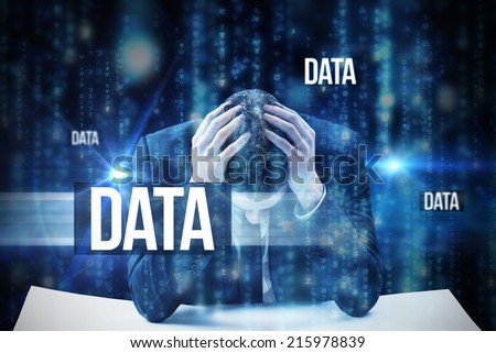 The word data and businessman with head in hands against lines of blue blurred letters falling