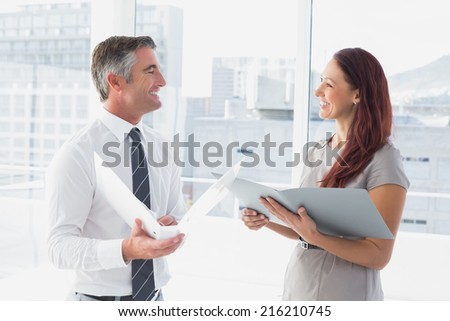 Business people smiling and talking at work