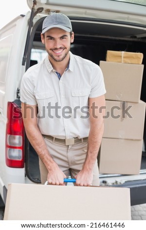 Delivery driver loading his van with boxes outside the warehouse