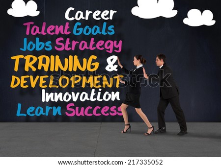 Composite image of business team standing and pushing against buzz words in room